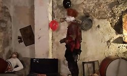 A Horror Clown Mocks Schoolgirl In An Abandoned Building