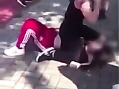 Woman Sits On Opponents Face During A Street Fight