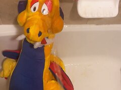 An XL Plush Dragon Gets A Face Full Of Piss