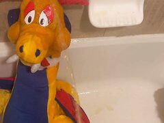 An XL Plush Dragon Gets A Face Full Of Piss