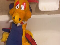 An XL Plush Dragon Gets A Face Full Of Piss